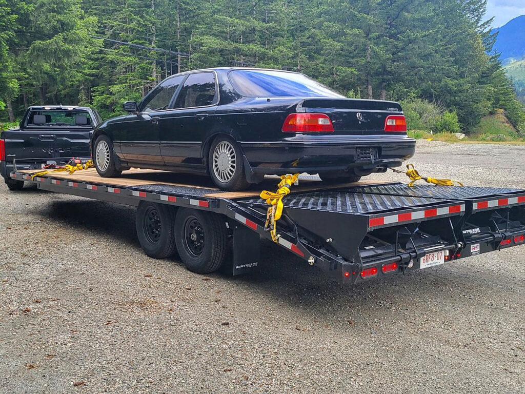A 20 ft Deck Over Rental Trailer hauling a car