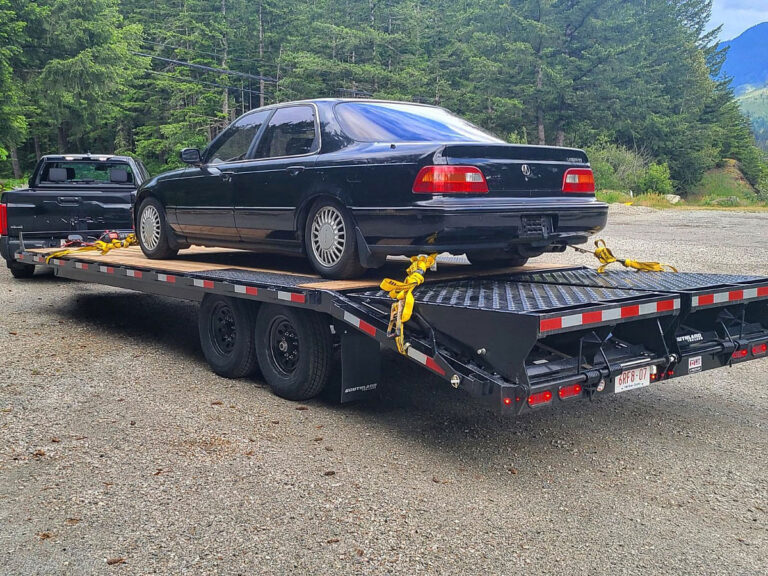 A 20 ft Deck Over Rental Trailer hauling a car