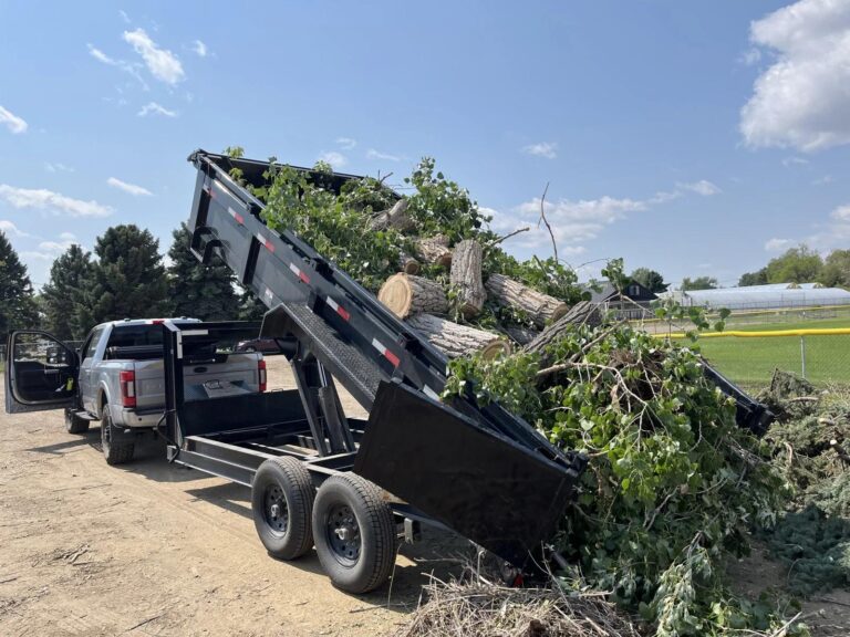 A trailer loaded with branches, brush, leaves, sod, or landscaping debris.